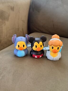 Disney character rubber ducks featuring Stitch, Mickey Mouse, and Cinderella